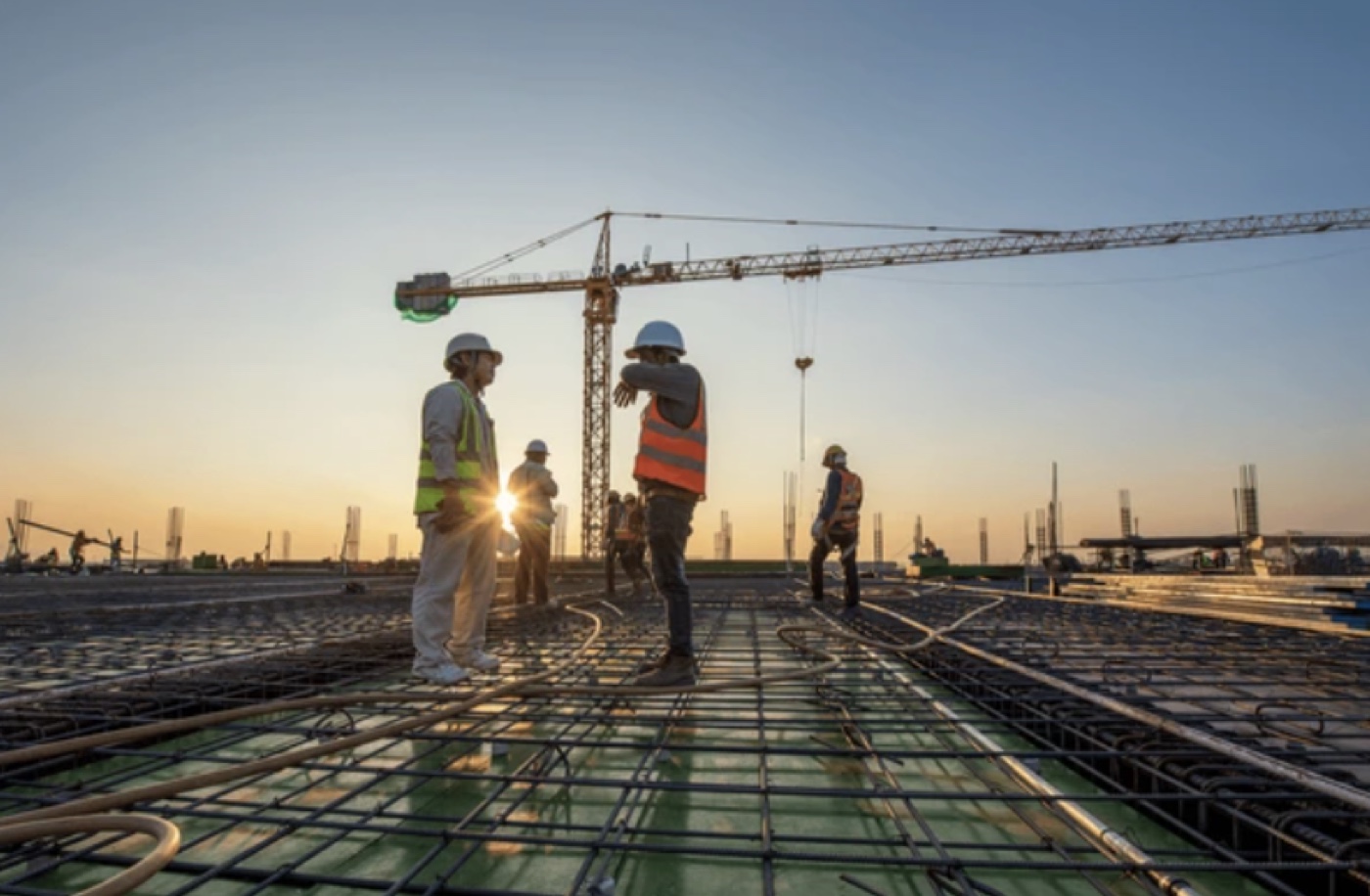Desconstructions crew working on a build site at dusk